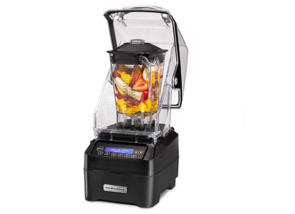 A blender filled with fruit and the Quiet Shield up