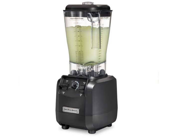 Blender full of cocktail mixture from the side view