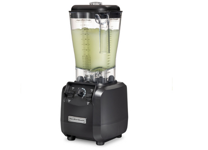 Blender full of cocktail mixture from the side view