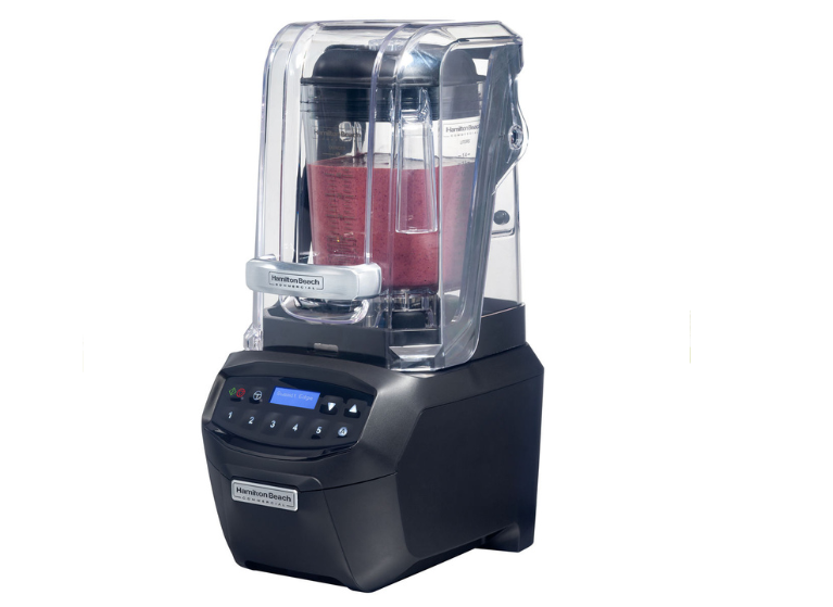 A blender full of smoothie mixture taken from the side view